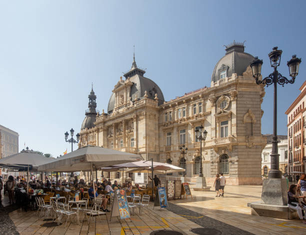 Tourist dining alfresco out side Cartagena's Magnificent City Hall  on a clear warm summers day. stock photo