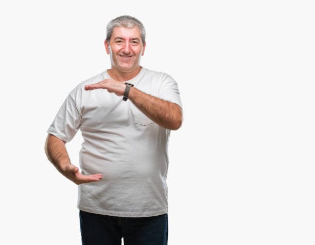istock Handsome senior man over isolated background gesturing with hands showing big and large size sign, measure symbol. Smiling looking at the camera. Measuring concept. 1097802862