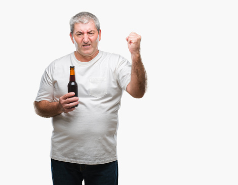 Handsome senior man drinking beer bottle over isolated background annoyed and frustrated shouting with anger, crazy and yelling with raised hand, anger concept
