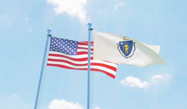 istock USA and state Massachusetts, two flags waving against blue sky 1097803696