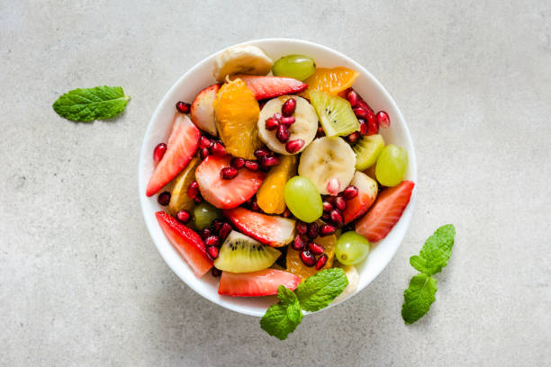 istock Fresh fruit salad on bright background, healthy diet concept 1097803782