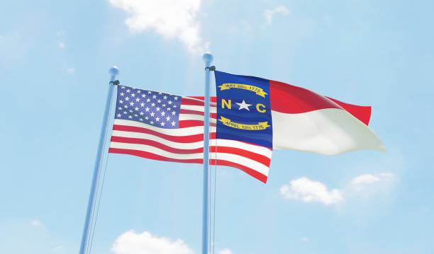 istock USA and state North Carolina, two flags waving against blue sky 1097803964