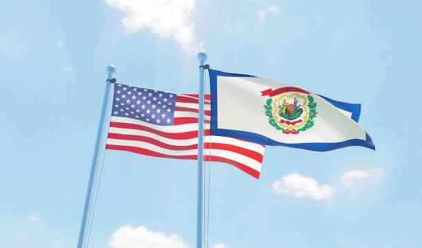 istock USA and state West Virginia, two flags waving against blue sky 1097804310