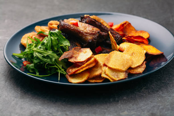 istock Grilled pork ribs with potato chips 1097808294