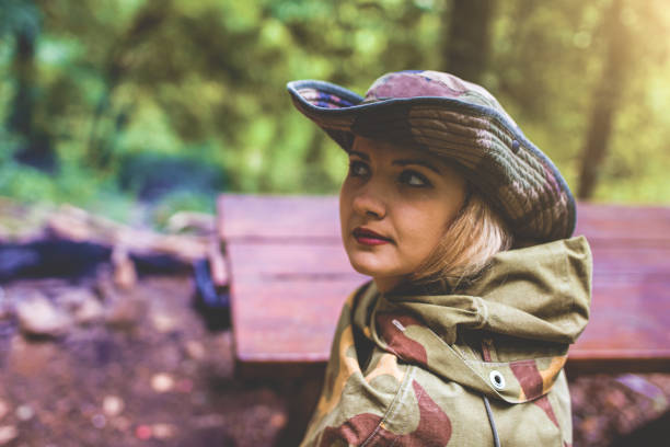 Camouflage woman in the forest