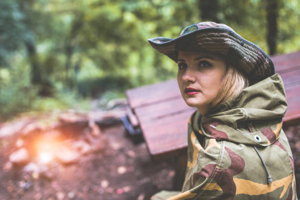 istock Camouflage woman in the forest 1097810234