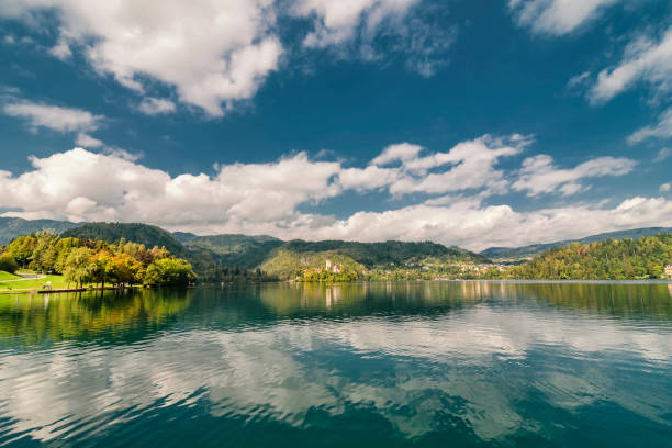 istock Vibrant landscape with blue sky and clouds reflecting in the lake 1097810242