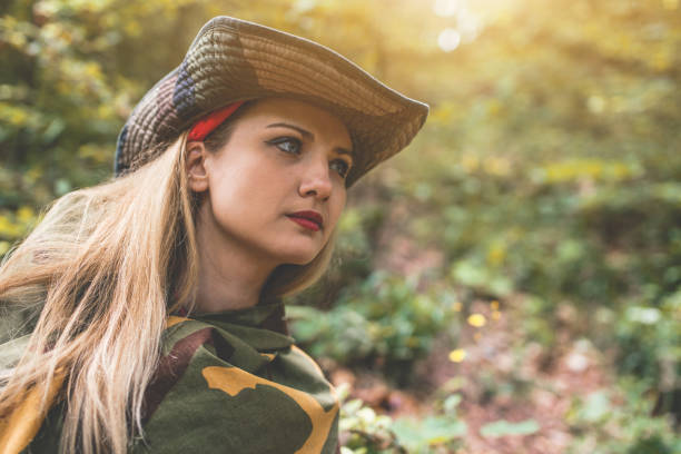 istock Camouflage woman in the forest 1097810280