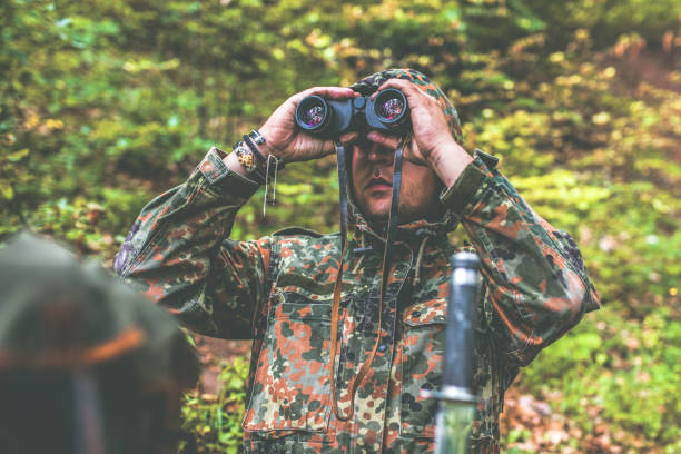 istock Camouflage woman in the forest 1097810428