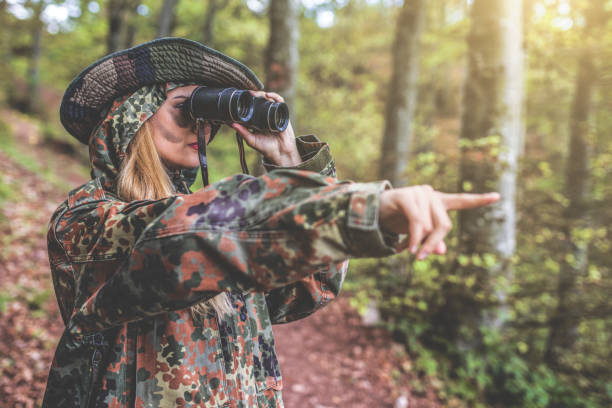istock Camouflage woman in the forest 1097810866