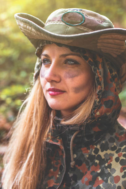 istock Camouflage woman in the forest 1097811118