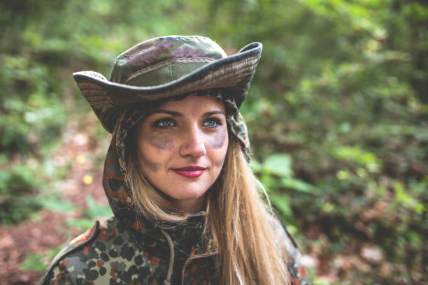 istock Camouflage woman in the forest 1097811208