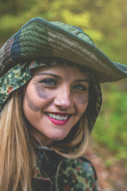 istock Camouflage woman in the forest 1097811218