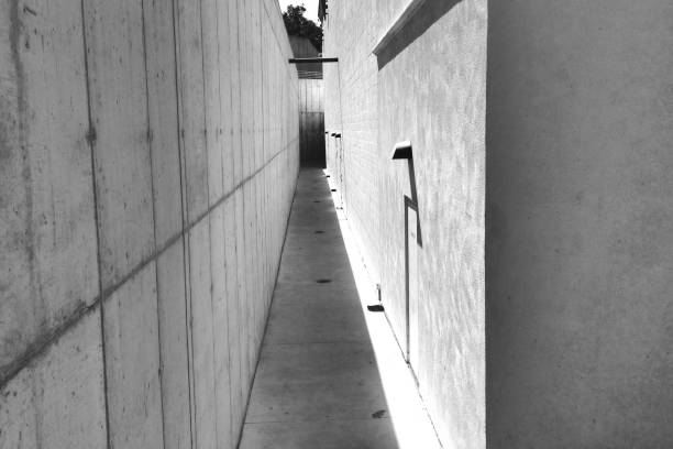 istock Alley with hard shadows and lines - High Angle - Black and White 1097812858