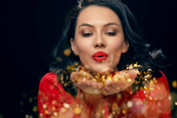 istock woman in red sweater on black background 1097813108