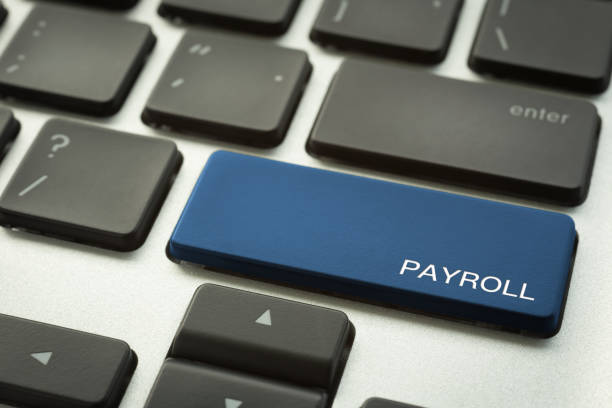 Laptop keyboard button with word PAYROLL. Close up blue button laptop keyboard selective focus on word PAYROLL. Human resources, salary, accounting, financial and business administration concepts. paycheck photos stock pictures, royalty-free photos & images