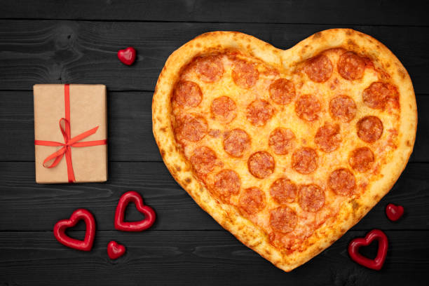 istock Pizza heart for Valentine's Day romantic concept copy space on rustic dark black background. Top View. Flat lay 1097817490