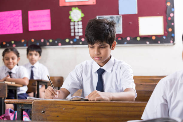 istock Schoolkids in classroom - Stock image 1097817718