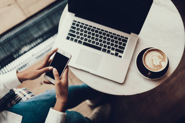 istock Lady holding her phone in hands against notebook 1097823314