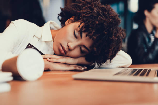 istock Exhausted lady with closed eyes sleeping inside cafe 1097823464