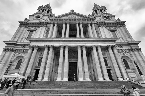 London, England - February 23, 2018:Saint Paul's Cathedral in London. The west facade at the end of the Strand on Ludgate Hill with tourists on the path and steps to the cathedral