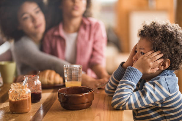 istock Sad African American boy crying during breakfast time at dining table. 1097831690