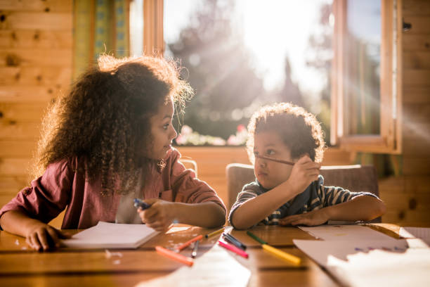 istock Small African American kids communicating while drawing at home. 1097833448