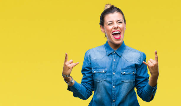 istock Young beautiful woman over isolated background shouting with crazy expression doing rock symbol with hands up. Music star. Heavy concept. 1097834556