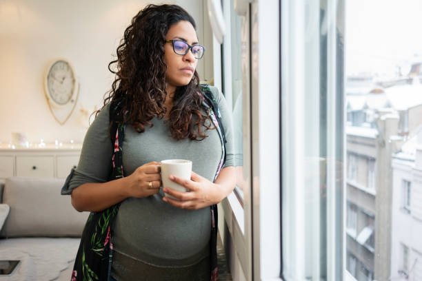 kobieta w ciąży pije kawę w domu - pre hispanic zdjęcia i obrazy z banku zdjęć