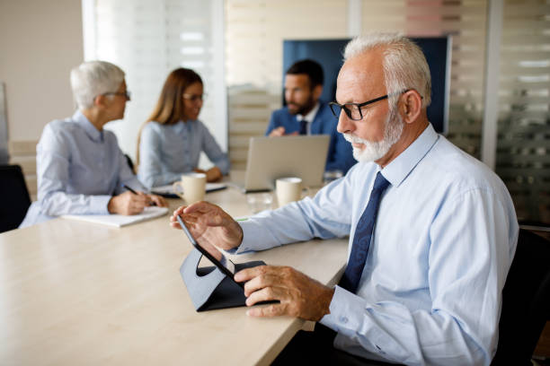 istock Senior businessman working on digital tablet in an office 1097836466