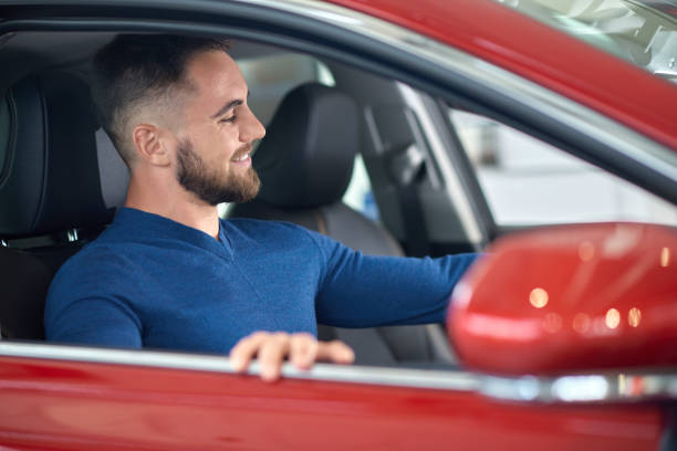 istock Attractive customer in blue sweater choosing auto in salon. 1097840202