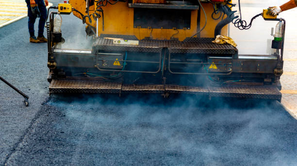 istock Workers regulate tracked paver laying asphalt heated to temperatures above 160 ° pavement on a runway 1097843816