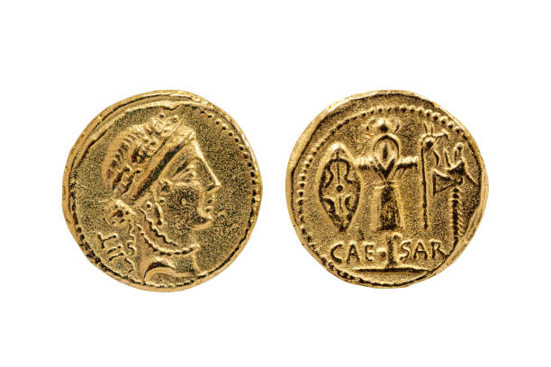 Roman Aureus Gold Coin replica of Julius Caesar Roman Aureus Gold Coin replica of Julius Caesar with a probable portrait of the goddess Venus and a Trophy of Gallic Arms on the reverse struck between 48-47 BC cut out and isolated on a white background ancient roman civilization stock pictures, royalty-free photos & images