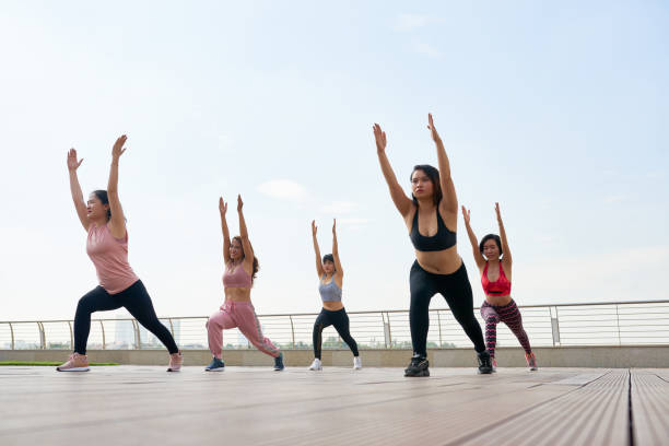 Women doing exercises in group outdoors