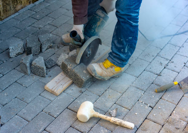 istock Worker cuts a tile to size with an electric grinder to complete the self-locking paving 1097844314