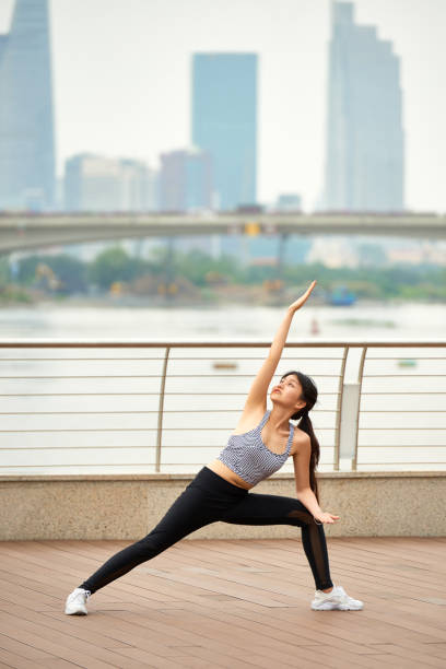 istock Ethnic woman practicing yoga on waterfront 1097844506