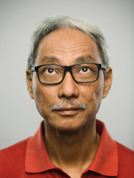 istock Real chinese senior man with blank expression looking up 1097847386