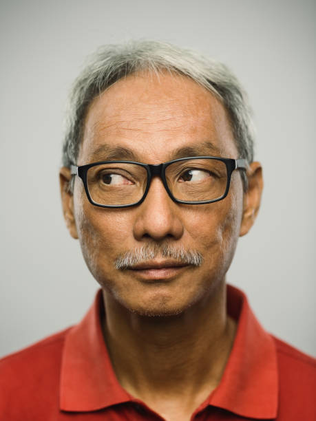 istock Real chinese senior man with blank expression looking to the side 1097847406