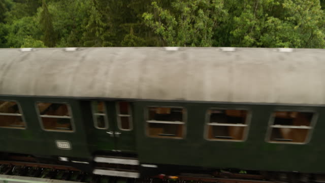 Aerial of old steam train on a trestle from above looking down