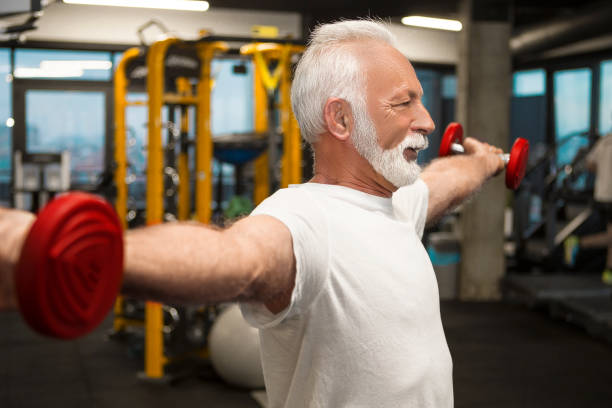 istock Senior man with dumb bells traning 1097851930