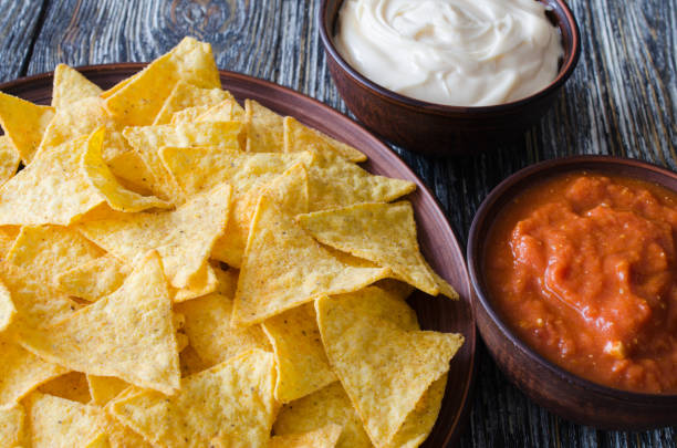 istock Nachos corn chips with spicy tomato and cheese sauces. 1097852178