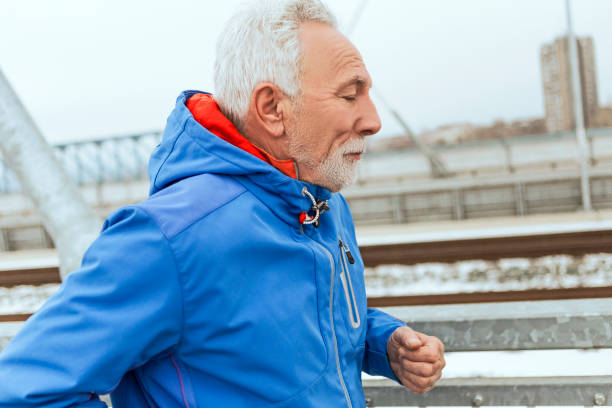 istock Active senior man running through city 1097852370