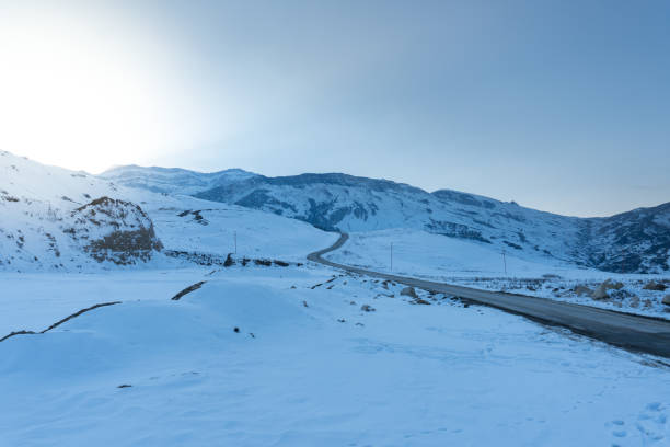 istock At a snowy mountain peak. Half of Mountain range covered with snow. 1097852726