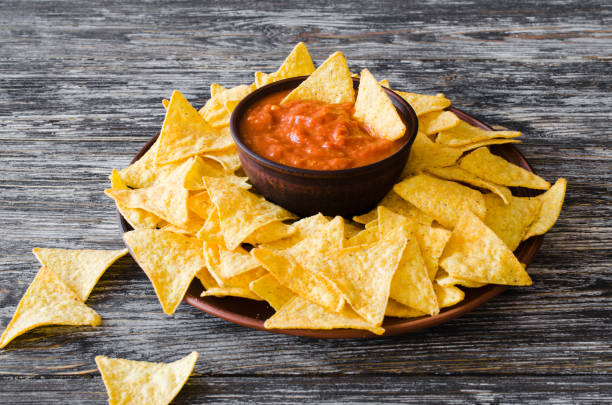 istock Nachos corn chips with spicy tomato sauce. 1097854340
