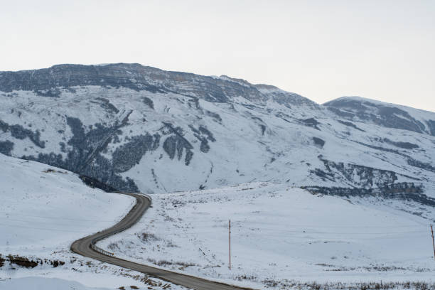 istock At a snowy mountain peak. Half of Mountain range covered with snow. 1097855096