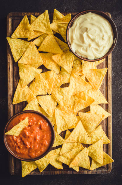 istock Nachos corn chips with spicy tomato and cheese sauces. 1097855344