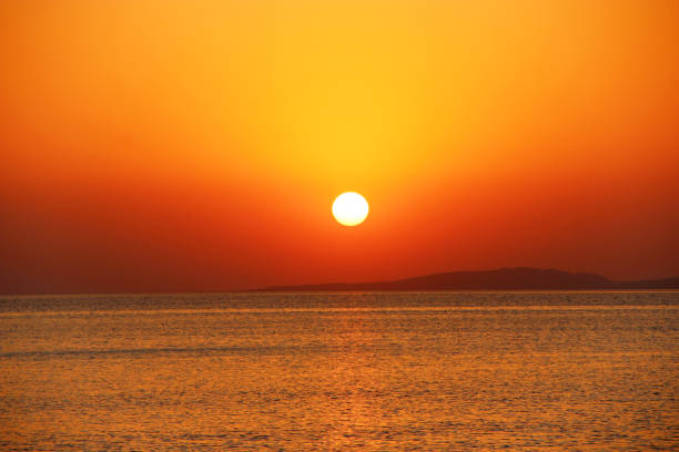 istock bright sunset above sea. Beautiful red summer decline above ocean 1097863446
