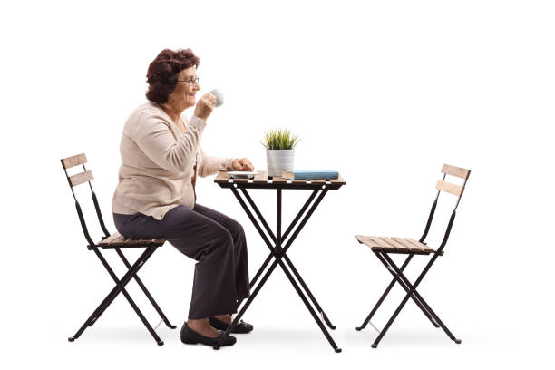 istock Senior woman drinking coffee at a table 1097864984