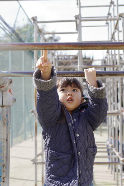 istock Japanese girl playing with a monkey bars (4 years old) 1097865702