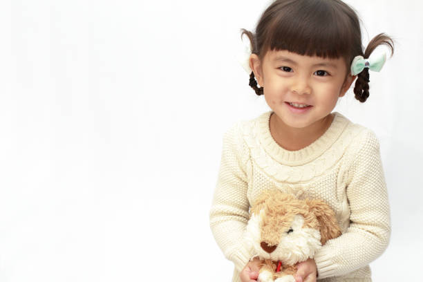 istock Japanese girl holding a stuffed rabbit (4 years old) (white back) 1097867926